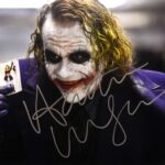 A signed Heath Ledger Joker photo, autographed a month before his death, sold for £5,460 at auction - 13 times its estimate. The rare collectible drew intense bidding.