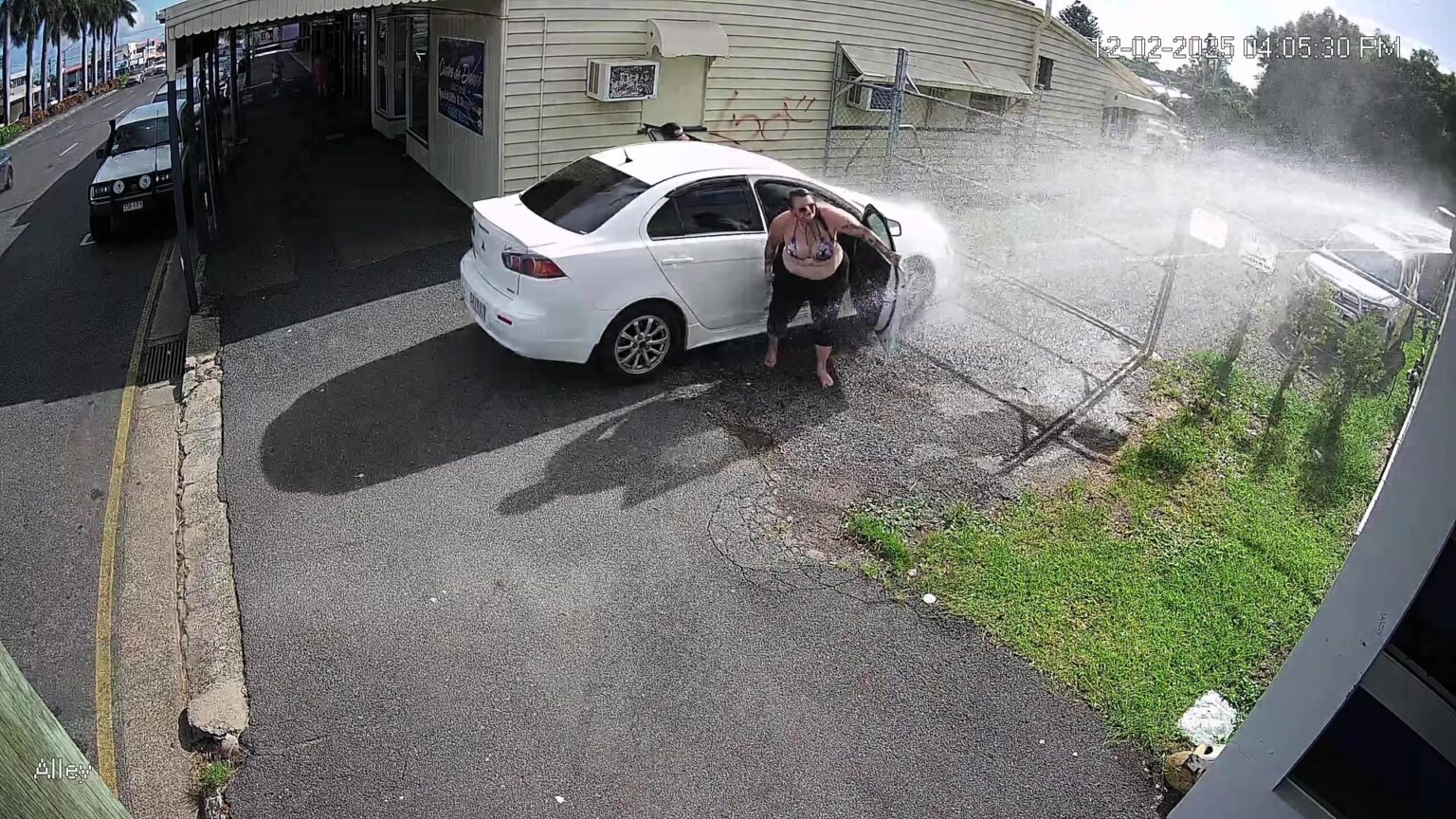 A fed-up business owner installed a motion-triggered sprinkler to drench drivers blocking his driveway in Australia - and the hilarious footage has gone viral.