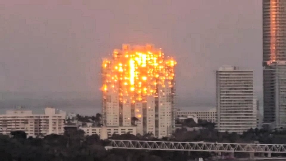 A stunning optical illusion of a ‘burning’ skyscraper in Miami leaves Instagram users baffled - but it’s just the sunset playing tricks with the building’s windows.