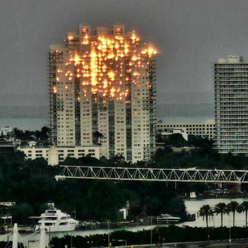 A stunning optical illusion of a ‘burning’ skyscraper in Miami leaves Instagram users baffled - but it’s just the sunset playing tricks with the building’s windows.