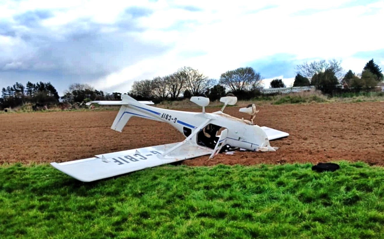 Two people survived with minor injuries after a light aircraft flipped on landing at Westonzoyland Airfield, Somerset, prompting an air safety investigation.