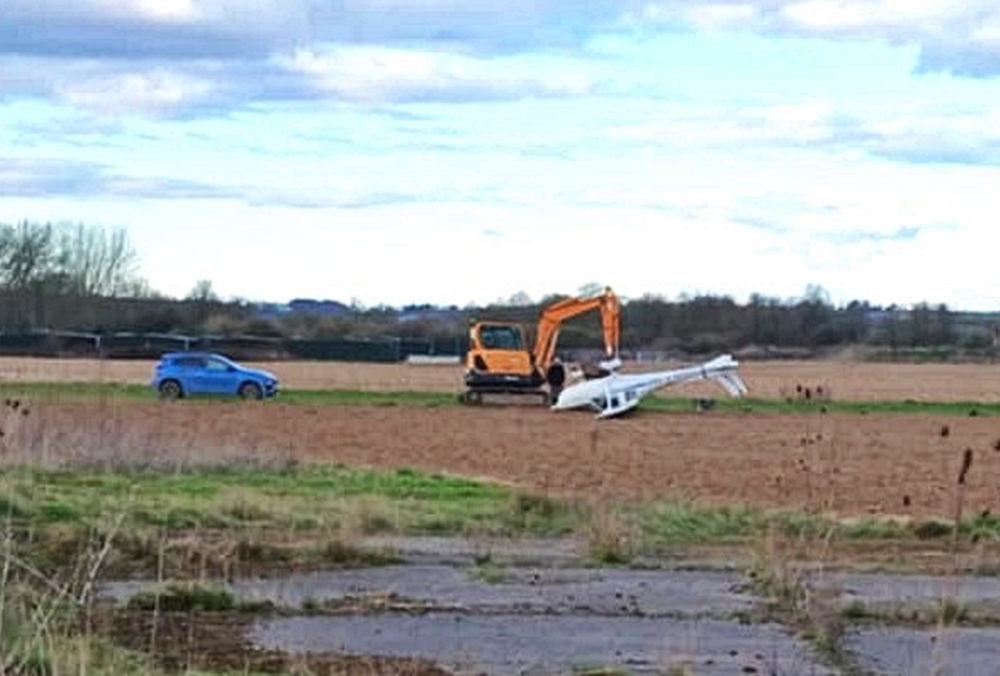 Two people survived with minor injuries after a light aircraft flipped on landing at Westonzoyland Airfield, Somerset, prompting an air safety investigation.