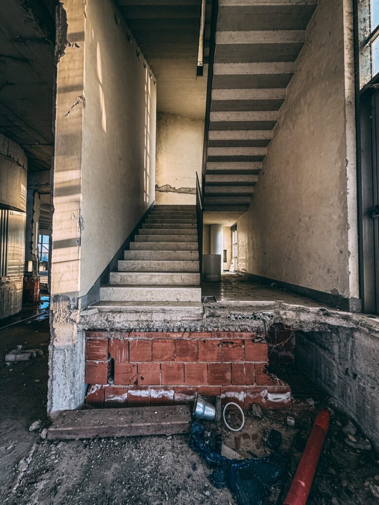 Urban explorer reveals inside abandoned Bugatti factory in Italy - once home to luxury cars, now filled with ruins, paint bottles and a spinning showroom floor.