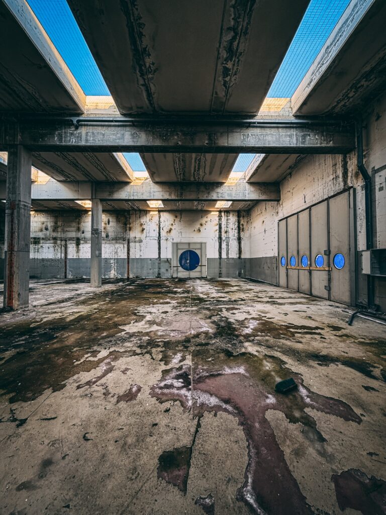 Urban explorer reveals inside abandoned Bugatti factory in Italy - once home to luxury cars, now filled with ruins, paint bottles and a spinning showroom floor.