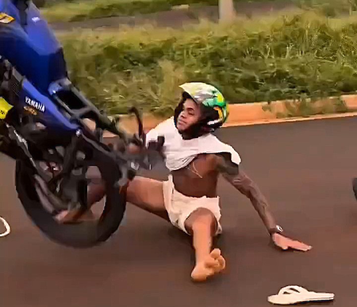 A motorcyclist’s daring wheelie went painfully wrong as he crashed onto the tarmac, skidding on his backside and losing control of his bike – all while wearing just flip-flops and a t-shirt.