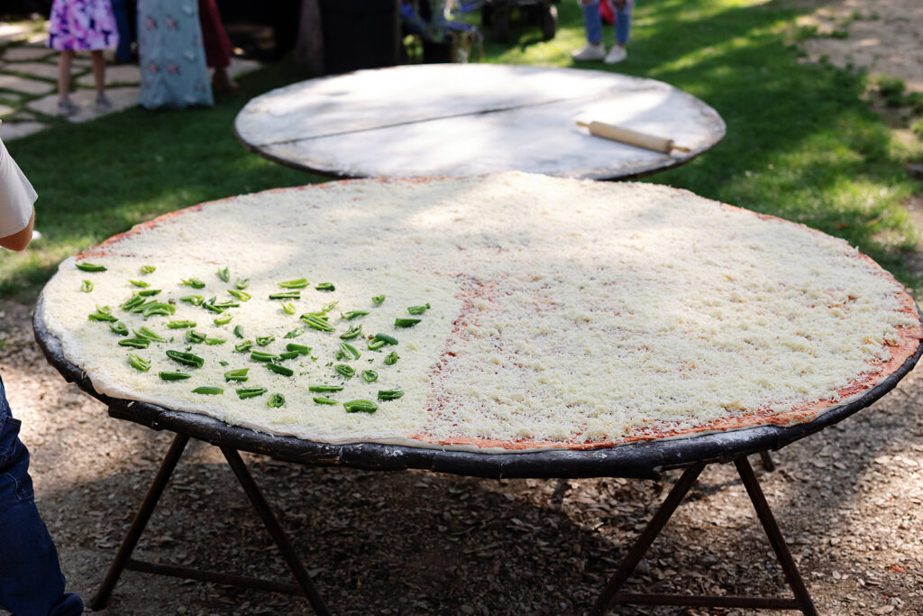 Pizza lovers Beth and Brandon Duhon served an 8ft pie and heart-shaped pizza at their wedding, turning their big day into a cheesy, unforgettable feast for 160 guests.