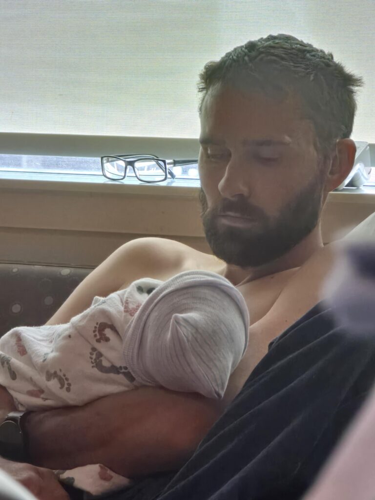 Dad-to-be brings TV and Xbox to hospital for birth, sparking backlash on TikTok - but partner reveals it was all to comfort her, not game, during labour stay.