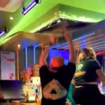 A football fan celebrating to YMCA accidentally ripped down a bar ceiling in the Netherlands after falling off a stool and grabbing the panel, startling staff and patrons.