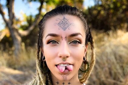 Body mod fan Flower relearned to speak after a painful tongue split, part of her £8.5k transformation including tattoos, piercings, and plans for ear pointing and fangs.