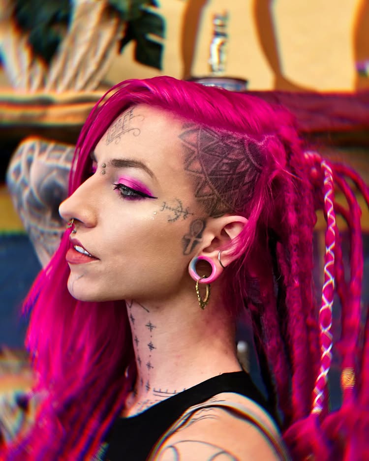 Body mod fan Flower relearned to speak after a painful tongue split, part of her £8.5k transformation including tattoos, piercings, and plans for ear pointing and fangs.