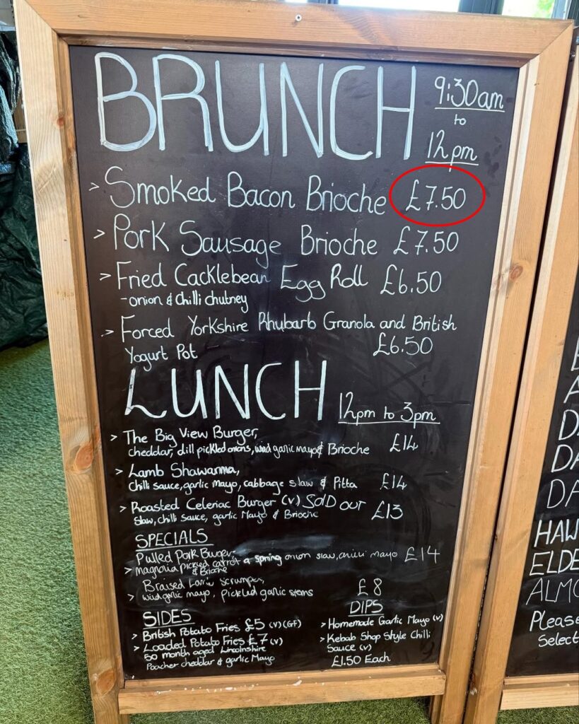Jeremy Clarkson is facing backlash for charging £7.50 for a bacon roll and £14 for a burger without chips at his country pub, with critics calling the prices greedy.