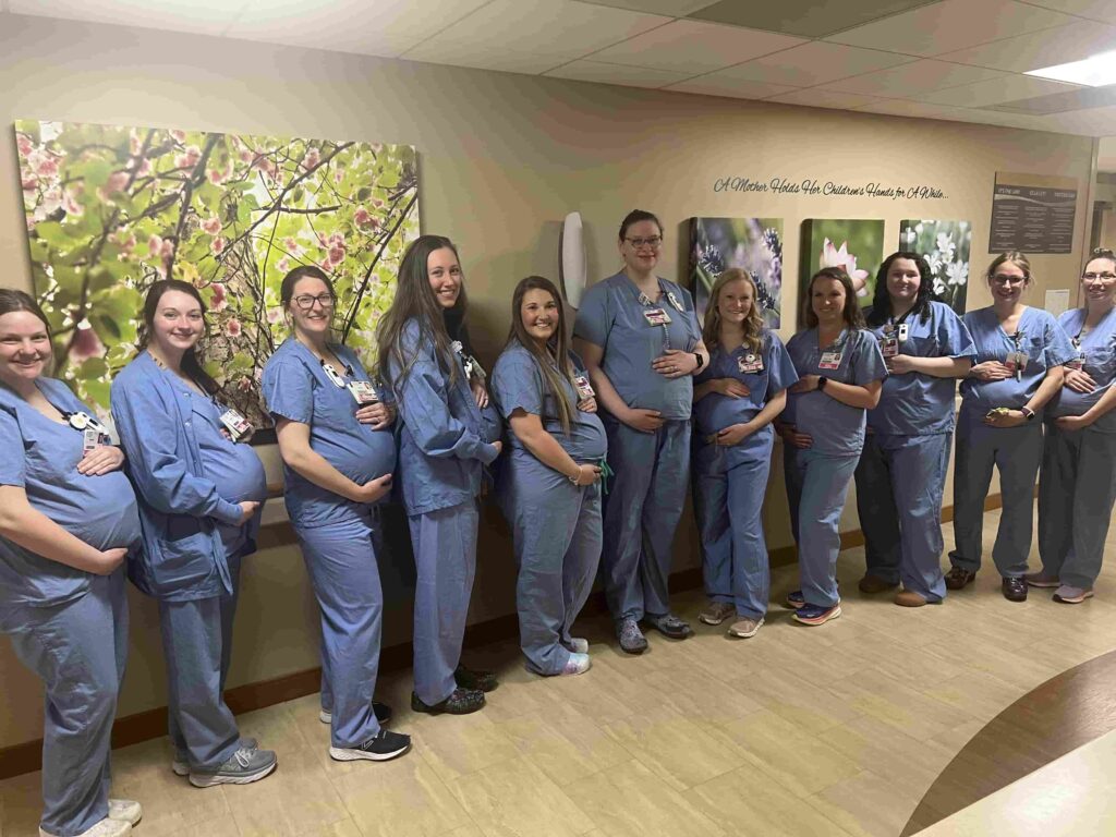 Fourteen nurses at HSHS St Vincent Hospital in Wisconsin are all pregnant at once - receiving care from their own colleagues in a heartwarming full circle maternity moment.