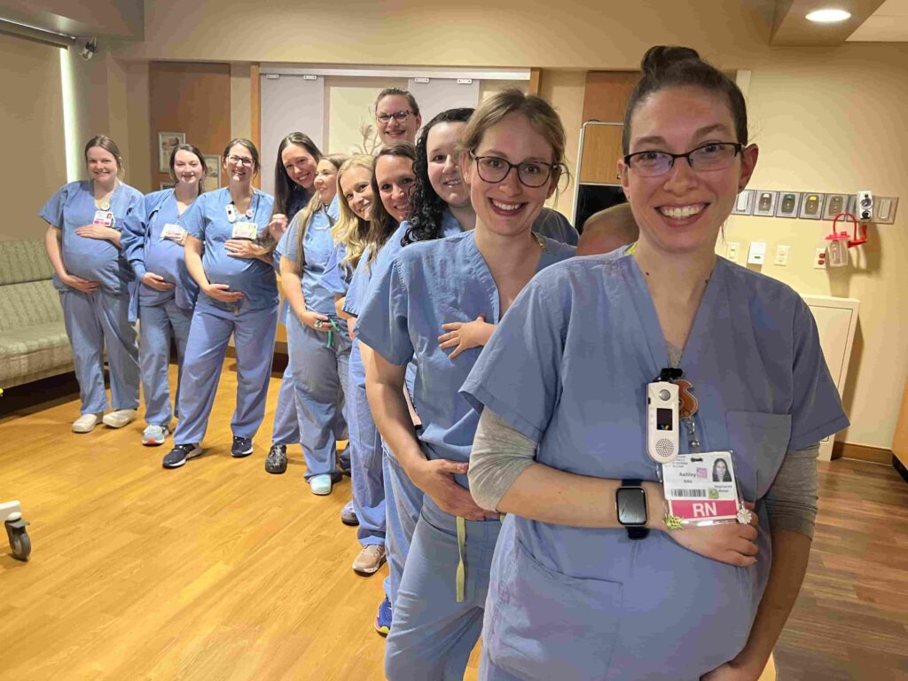 Fourteen nurses at HSHS St Vincent Hospital in Wisconsin are all pregnant at once - receiving care from their own colleagues in a heartwarming full circle maternity moment.