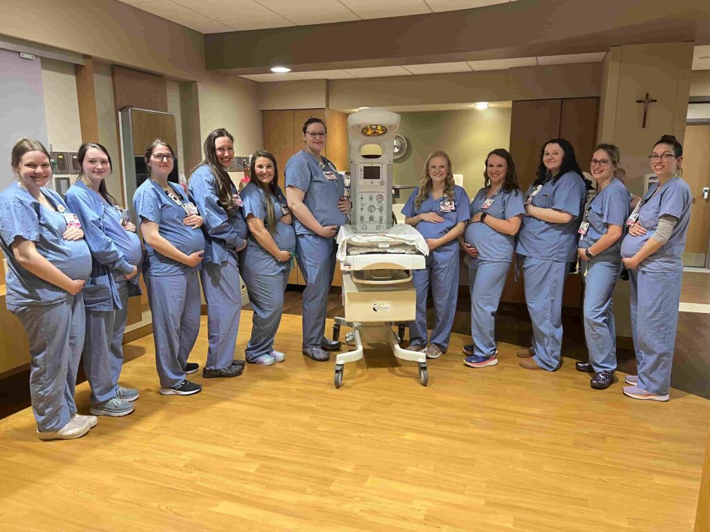 Fourteen nurses at HSHS St Vincent Hospital in Wisconsin are all pregnant at once - receiving care from their own colleagues in a heartwarming full circle maternity moment.