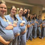 Fourteen nurses at HSHS St Vincent Hospital in Wisconsin are all pregnant at once - receiving care from their own colleagues in a heartwarming full circle maternity moment.