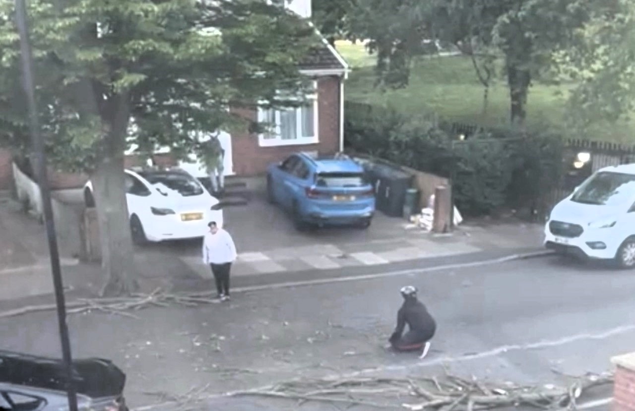 A man narrowly avoided injury as a massive tree branch crashed down just feet from him in Southall, west London. Locals helped clear the debris to keep the road safe.