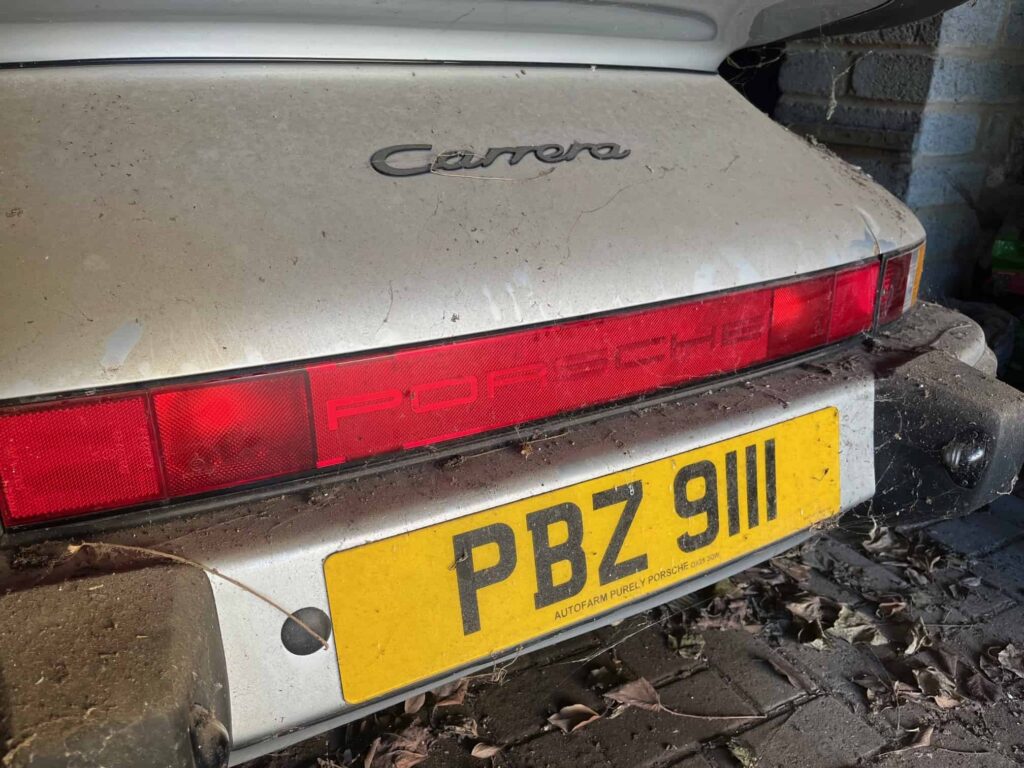 A dust-covered 1989 Porsche 911 Carrera Sport stored in a barn since 2011 has sold for £76,500 at auction, over triple its estimate, captivating collectors worldwide.