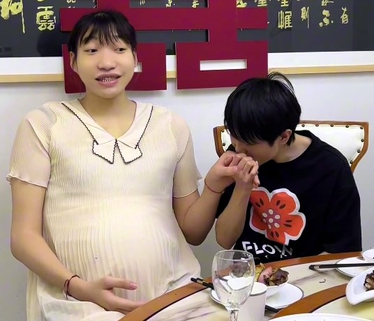 7ft woman expecting baby with 5ft 5in boyfriend hits back at fake bump claims - couple plan June wedding and vow lifelong commitment despite family objections.