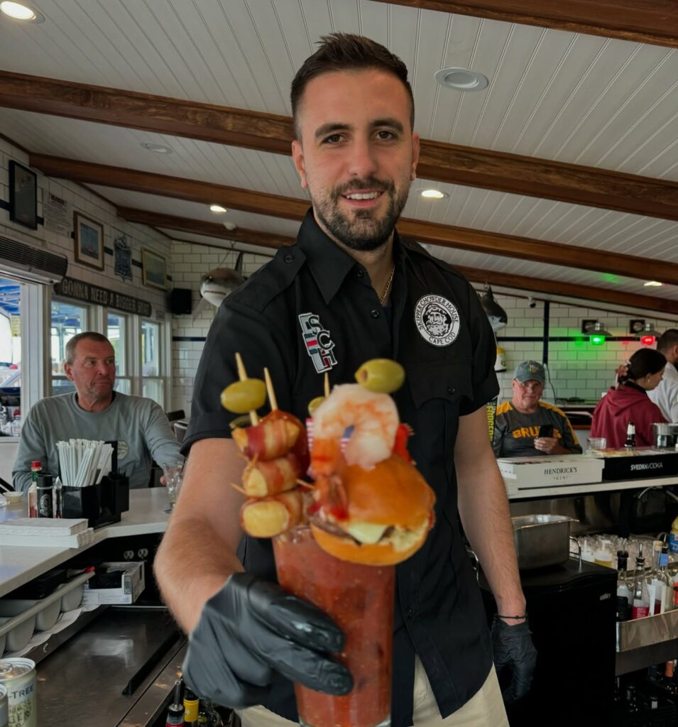 A viral Bloody Mary from Skipper Chowder House in Cape Cod stuns with its towering stack of lobster, shrimp, a burger, and more, earning fame as the East Coast’s wildest cocktail.