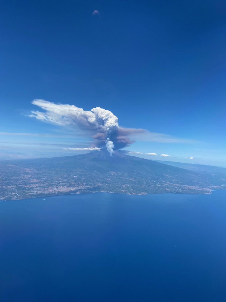 A British couple saw Mount Etna erupt from their plane just hours after racing up the volcano during a championship in Sicily, capturing a dramatic and rare sight.