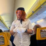 Groom-to-be pranked as cabin crew on flight to stag do - dons uniform, helps with safety demo and rubbish collection as passengers and Ryanair staff enjoy the laughs.