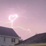 Teen captures heart-shaped lightning bolt during storm over Tweedbank village - rare pink sky flash stuns locals and sparks emotional reactions online.