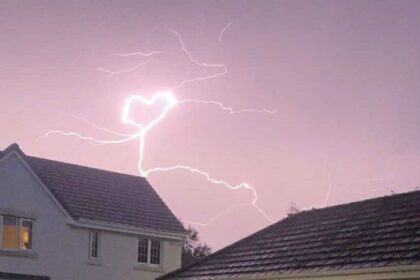 Teen captures heart-shaped lightning bolt during storm over Tweedbank village - rare pink sky flash stuns locals and sparks emotional reactions online.
