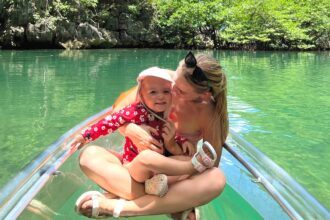 Backpacking mum Kaylie Bryson defends letting toddler kayak without life jacket in viral video from the Philippines - says calm waters and safety training made it a safe choice.