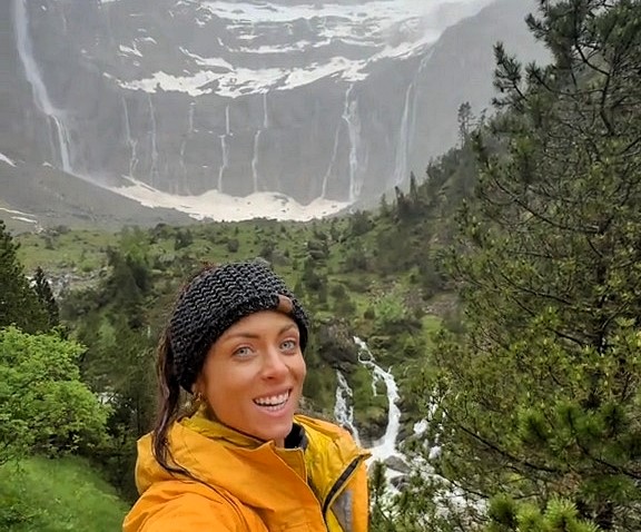 Hiker Grace Kelly discovered the breathtaking Cirque de Gavarnie in the French Pyrenees during a rainy trek, calling it a magical waterfall wonderland and her most unforgettable view.
