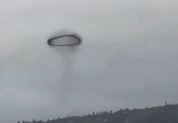 A mysterious black ring spotted in the sky over La Palma sparked UFO speculation, but experts say it was likely a vortex ring from fireworks or a small explosion.