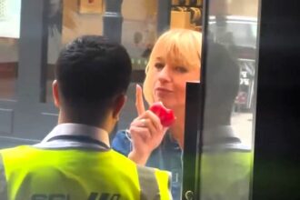 Radio DJ Sara Cox was hilariously delayed entry to a Soho bar for eating an apple - her co-host filmed the moment as the bouncer made her finish it before letting her in.