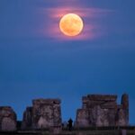 A rare Strawberry Moon lit up Stonehenge for the first time in 18 years, captured in a stunning image by Abby Moule after two years of planning for the lunar standstill.