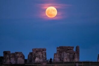 A rare Strawberry Moon lit up Stonehenge for the first time in 18 years, captured in a stunning image by Abby Moule after two years of planning for the lunar standstill.