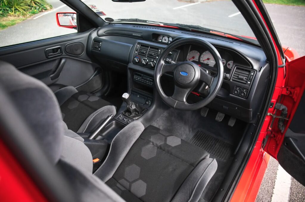 A 1993 Ford Escort RS Cosworth sold for £105,750 in time-warp condition with just 12,530 miles, rare specs and complete original documentation from its sole owner.