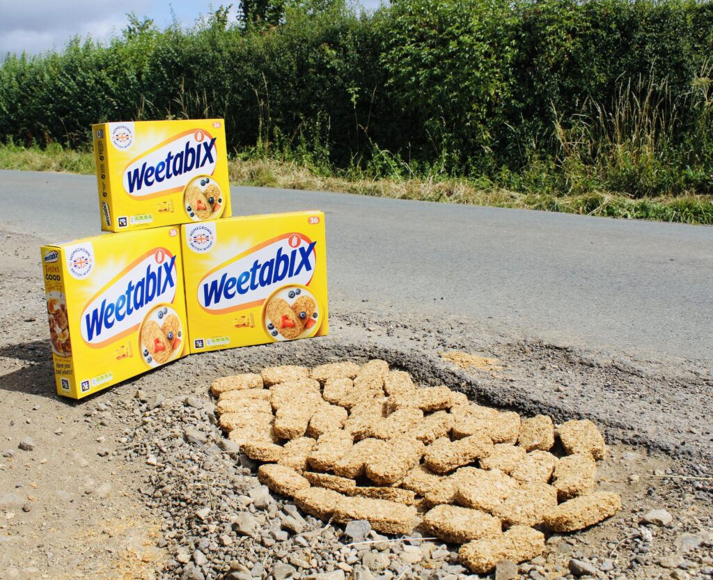 Angry Brit fills Gloucestershire pothole with Weetabix to protest road conditions - cyclists cheer as stunt draws attention to council inaction and sparks viral reaction.
