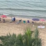 Brit tourist stunned as holidaymakers claim Benidorm beach spots at 6.30am with towels, chairs and brollies, sparking outrage and calls for fines over early beach hogging.