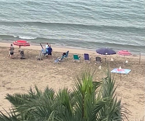 Brit tourist stunned as holidaymakers claim Benidorm beach spots at 6.30am with towels, chairs and brollies, sparking outrage and calls for fines over early beach hogging.