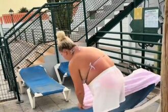 Mum-of-six sparks outrage by reserving nine sunbeds before breakfast on family holiday in Fuerteventura as furious Brits slam her controversial poolside tactic.