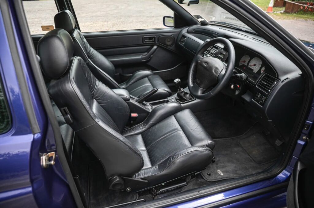 A rare 1996 Ford Escort RS Cosworth Lux with just 22,744 miles and one owner is up for auction at £90,000, boasting 150mph performance and collector appeal.