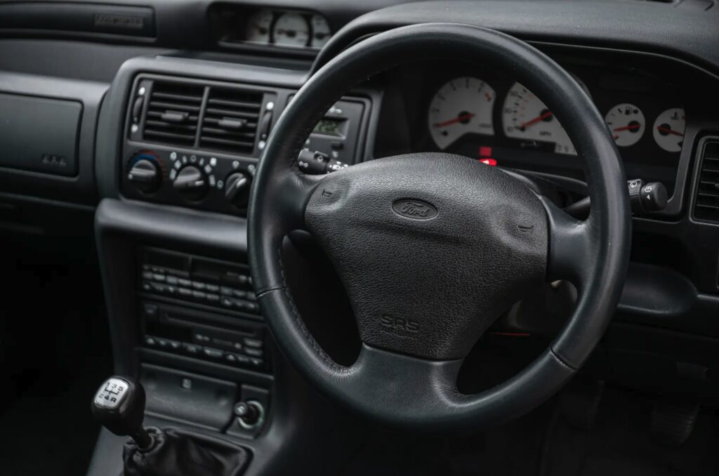 A rare 1996 Ford Escort RS Cosworth Lux with just 22,744 miles and one owner is up for auction at £90,000, boasting 150mph performance and collector appeal.