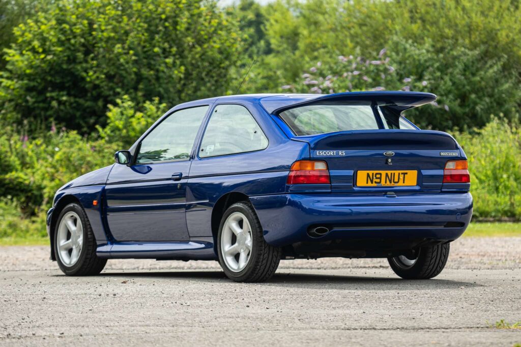 A rare 1996 Ford Escort RS Cosworth Lux with just 22,744 miles and one owner is up for auction at £90,000, boasting 150mph performance and collector appeal.
