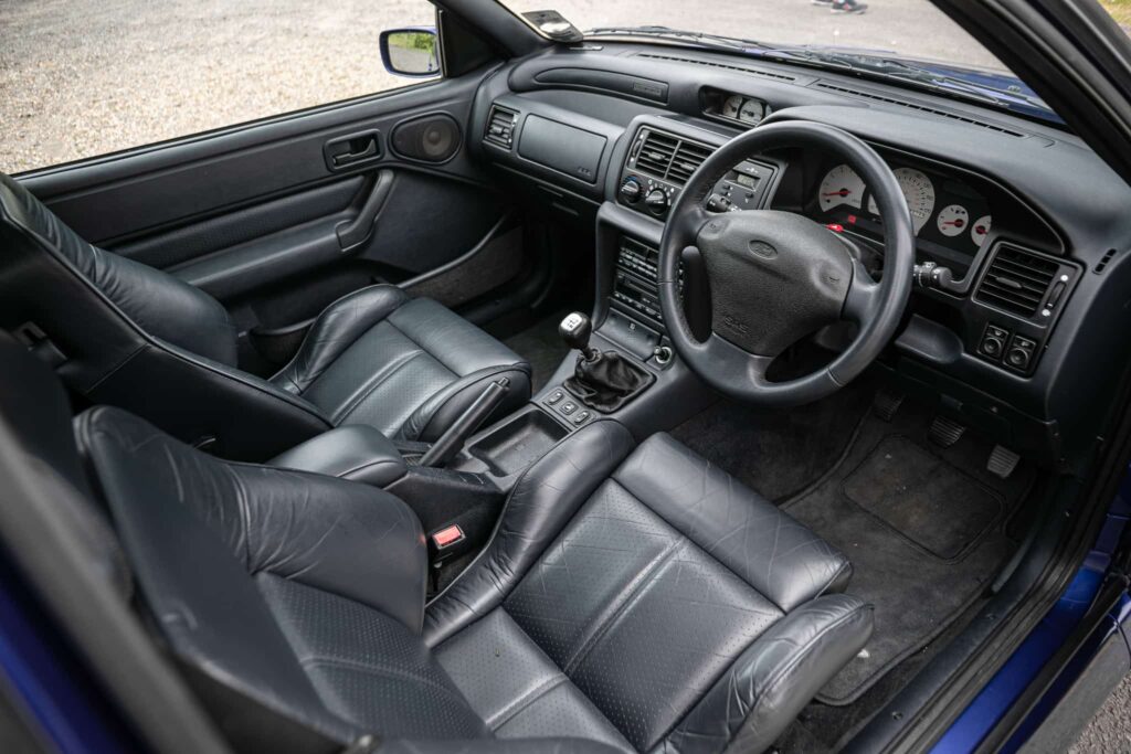 A rare 1996 Ford Escort RS Cosworth Lux with just 22,744 miles and one owner is up for auction at £90,000, boasting 150mph performance and collector appeal.