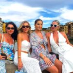 Four sisters flew to Italy for a birthday trip only to find their hotel booking was for 2026, ending up in a hot basement room but laughing through the unexpected adventure.