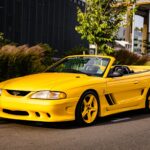 George Foreman’s 1995 Saleen Mustang, with only 728 miles and 510bhp, is up for sale at £9,300. This rare canary yellow convertible was rarely driven and heavily upgraded.