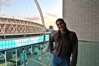 A woman living next to Wembley Stadium enjoys free concerts by Taylor Swift and Dua Lipa from her balcony, calling the high rent worth it for the view and vibrant atmosphere.