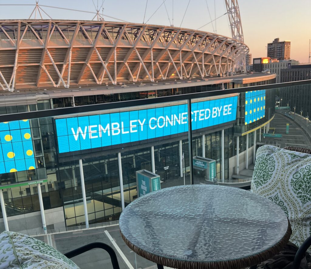 A woman living next to Wembley Stadium enjoys free concerts by Taylor Swift and Dua Lipa from her balcony, calling the high rent worth it for the view and vibrant atmosphere.