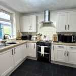 Dental nurse transforms dark kitchen for just £150 using paint, vinyl and DIY hacks, avoiding £3,000 renovation and stunning TikTok with her stylish budget makeover.