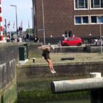 Parkour star Noa Diorgina Man goes viral after falling into Rotterdam river during a water challenge, with fans praising her grace and asking about her stylish outfit.