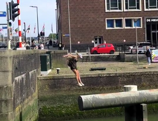 Parkour star Noa Diorgina Man goes viral after falling into Rotterdam river during a water challenge, with fans praising her grace and asking about her stylish outfit.