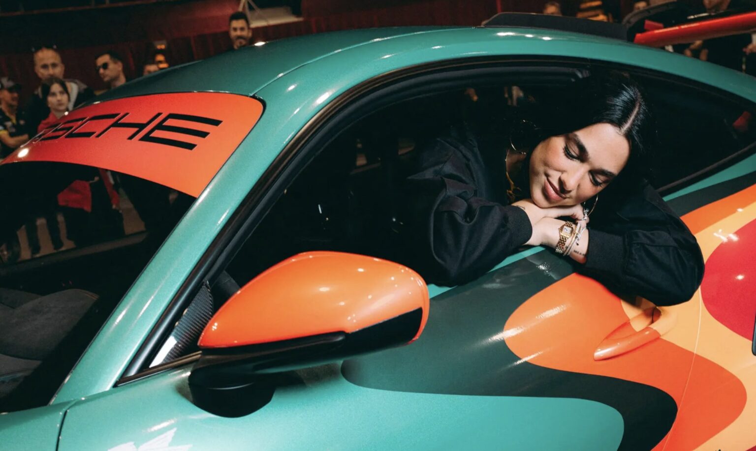 A unique Porsche 911 GT3 RS designed by Dua Lipa is up for auction at £345,000, with vibrant colors, 184mph speed and proceeds supporting her Sunny Hill Foundation.